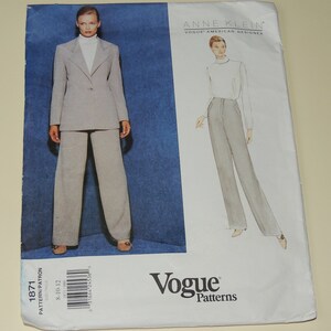 May include: A Vogue Patterns sewing pattern featuring an Anne Klein design. The pattern includes a suit with a blazer and wide-leg pants. The cover shows a model wearing the suit. The pattern number is 1871, and the size range is 8-10-12.