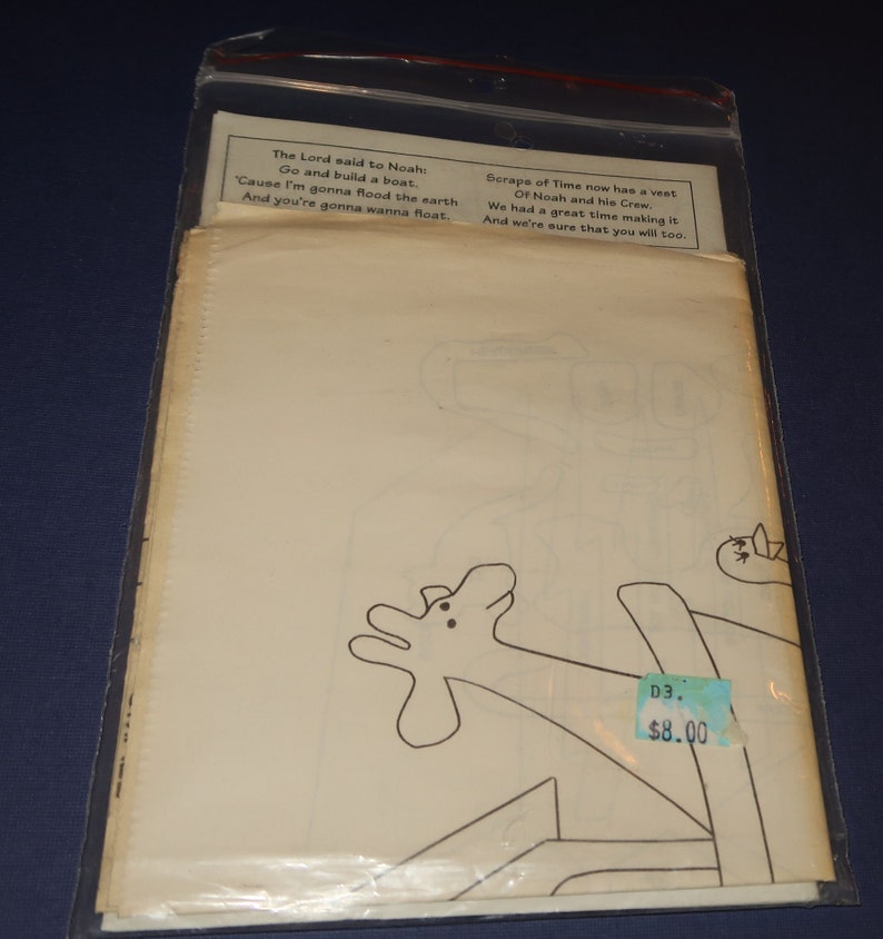 May include: A black and white line drawing of a giraffe with a price tag that says "D3. $8.00". The text "The Lord said to Noah: Go and build a boat. 'Cause I'm gonna flood the earth And you're gonna wanna float." is at the top of the image. The text "Scraps of Time now has a vest Of Noah and his Crew. We had a great time making it And we're sure that you will too." is at the top right of the image.