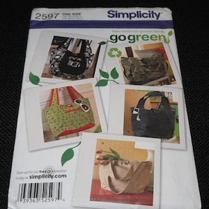 May include: Simplicity sewing pattern 2597, "go green" with five different tote bag designs. The bags are made from various fabrics, including camouflage, denim, and floral prints.