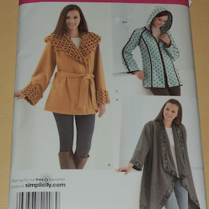 May include: Simplicity sewing pattern number 2208 for three different styles of jackets. The first jacket is a brown wrap jacket with a large collar and a belt. The second jacket is a teal blue jacket with black polka dots and a hood. The third jacket is a gray wrap jacket with a patterned trim.