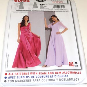 May include: A sewing pattern package featuring two evening gowns. One is a vibrant pink, the other a soft lavender. The package includes the text "Evening Dress" and "Plus -48 -22". The Burda brand is visible.