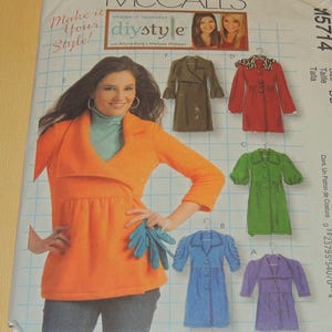 May include: McCall's DIY style sewing pattern featuring a woman in an orange top. The pattern includes illustrations of various coat designs in green, red, blue, and purple. The text "Make it Your Style!" is visible.