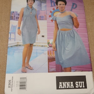 May include: A sewing pattern for a dress and a top and skirt set. The pattern is by Anna Sui and is for sizes 6-8-10. The pattern is on a white background with a photo of two models wearing the garments.