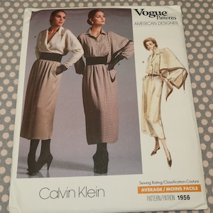 May include: A vintage Vogue sewing pattern for a dress and skirt designed by Calvin Klein. The pattern is for an average skill level and is labeled as pattern number 1956.