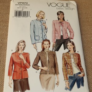 May include: Vogue basic design sewing pattern for a jacket. The pattern includes four different styles: a blue jacket with a white collar, a pink jacket with a bow, a brown tweed jacket, and a brown tweed jacket with a white trim. The pattern number is VP970.