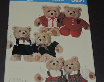 May include: Vogue Patterns 9572 craft pattern featuring teddy bears in various outfits. The bears are dressed in red, black, and plaid clothing. Designed by Linda Carr.