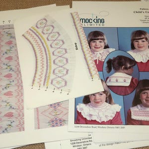 May include: Assortment of vintage sewing patterns for children's collars and baby smocking. The patterns include detailed illustrations and instructions. The patterns are printed on white paper with text and images in various colors. The patterns are from the brand "Smocking Unlimited".