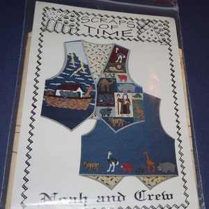 May include: A sewing pattern for a quilted vest featuring a Noah's Ark theme. The pattern is titled "Scraps of Time" and "Noah and Crew". The vest is made of blue denim with colorful patchwork squares depicting animals from the ark.