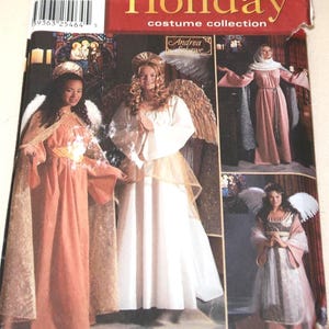 May include: Simplicity Holiday costume collection pattern featuring angel and religious themed costumes. The cover shows images of women in various costumes, including angels and a nun. The pattern includes sizes D8, L, and XL.