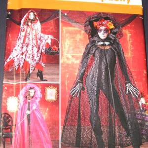 May include: A Simplicity S0259 sewing pattern envelope featuring three costume designs. One shows a white and red floral hooded cape, another a sheer pink hooded cape, and the third a black lace hooded cape worn over a black bodysuit with skeleton gloves.