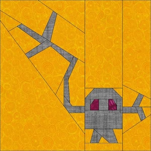 May include: A paper pieced quilt block featuring a stylized robot with a gray body and purple eyes. The robot is standing on a yellow background with a swirling pattern.