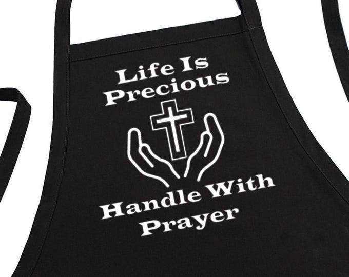 Spiritual Kitchen Apron Life Is Precious Handle With Prayer, Black Chef Apron With Two Front Pockets And An Adjustable Neck Strap