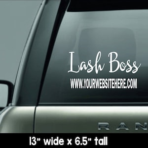 May include: White vinyl car decal with the text "Lash Boss" in a cursive font, with the website address below. The decal is 13 inches wide and 6.5 inches tall. The decal is displayed on a car window.