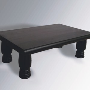 May include: A dark brown wooden coffee table with a rectangular top and four turned legs.