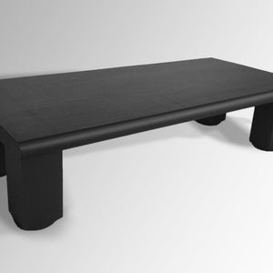 May include: A black wooden coffee table with a rectangular top and four short legs. The table has a slightly rounded edge.