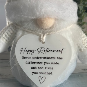 May include: White gnome figurine with a heart-shaped sign that reads "Happy Retirement. Never underestimate the difference you made and the lives you touched."