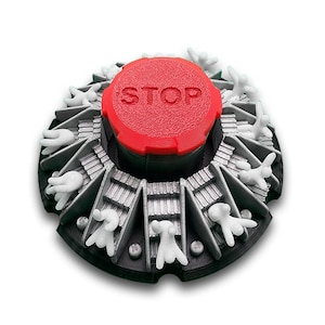 May include: A 3D-printed, circular object with a red top that reads "STOP." The object has a black base with gray compartments, each containing a white hand-shaped figure. The design is intricate and detailed.