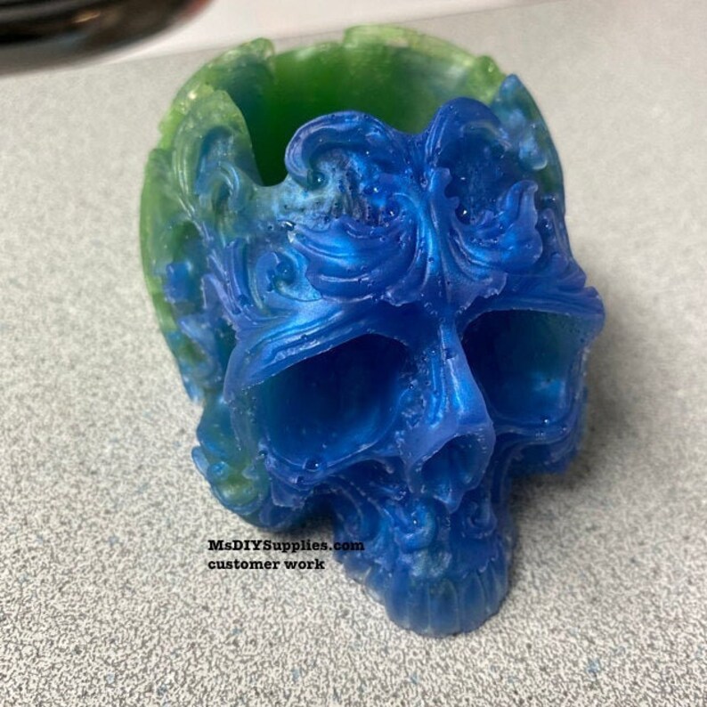 May include: A decorative skull-shaped container in shades of blue and green. The skull has intricate, swirling details and a glossy finish. The text "MsDIYSupplies.com customer work" is visible at the bottom.