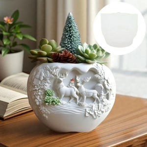 May include: White ceramic planter with a detailed relief of deer and a Santa figure. The planter is filled with succulents, a small green tree, and pine cones. A decorative piece for the home.