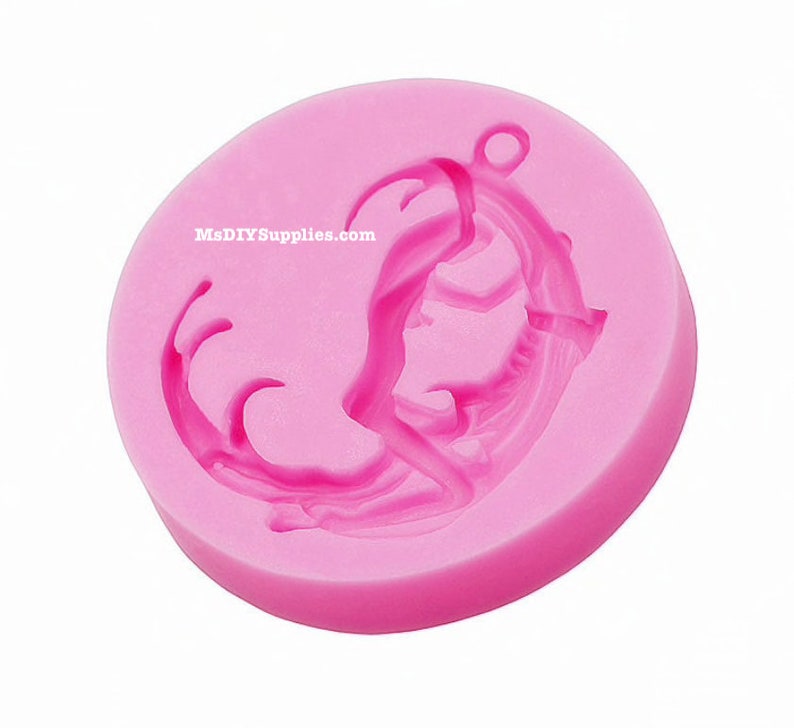 May include: A pink silicone mold with a mermaid design. The mold is round with a loop at the top for hanging. The mermaid design is detailed and includes the text MsDIYSupplies.com.