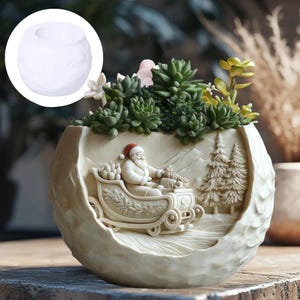 May include: A cream-colored, round planter with a detailed relief of Santa Claus in a sleigh, surrounded by pine trees and mountains. The planter is filled with green succulents and small white flowers. A smaller, plain white planter is in the upper left corner.