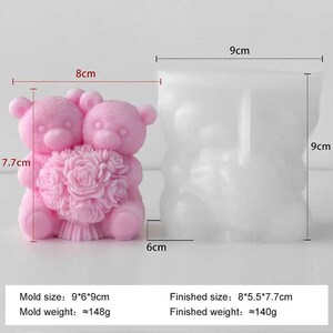 May include: A pink silicone mold for making a double teddy bear with a rose bouquet. The finished bear measures approximately 3.1 inches tall, 3.1 inches wide, and 2.2 inches deep. The mold itself is 3.5 inches tall, 3.5 inches wide, and 2.4 inches deep.