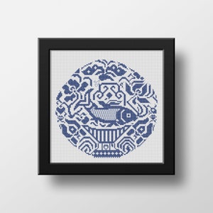 May include: A framed cross-stitch design featuring a blue fish surrounded by intricate floral and geometric patterns.