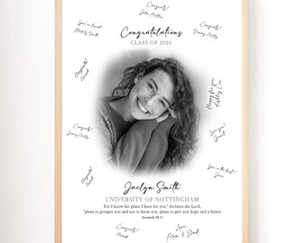 May include: A framed black and white graduation print featuring a smiling woman's portrait. The print includes the text "Congratulations Class of 2026" and the graduate's name, "Jaclyn Smith," along with signatures and well wishes.