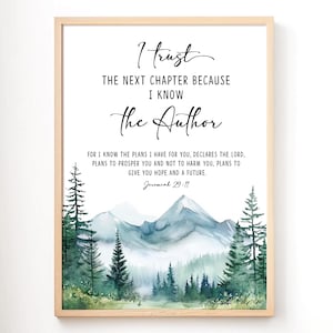 May include: A framed art print with the text "I trust the next chapter because I know the Author." The print features a watercolor landscape of mountains and trees in shades of green and blue.