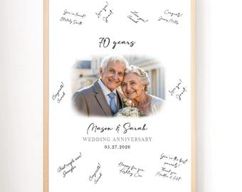 May include: A framed wedding anniversary print featuring a photo of an elderly couple. The print reads "70 years" and "Mason & Sarah WEDDING ANNIVERSARY 05.27.2026". Handwritten messages surround the photo, including "Love you!" and "Congrats!"