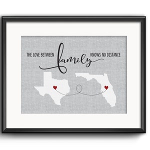 May include: A gray and white print with the text "The love between family knows no distance" and outlines of Texas and Florida with red hearts in each state. The states are connected by a dotted line.