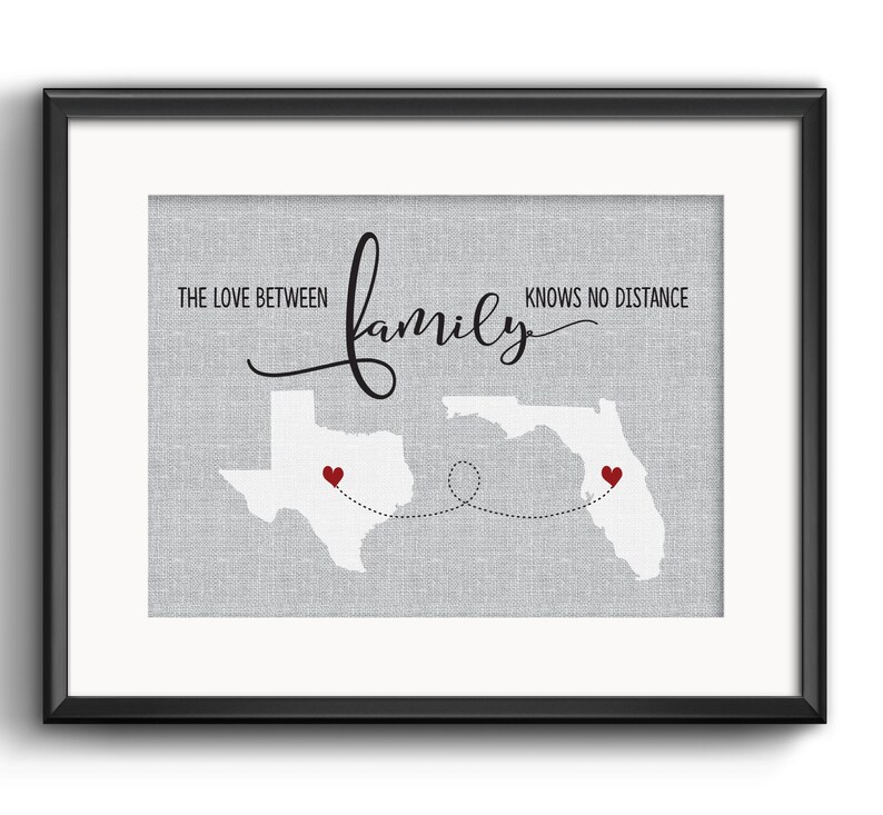 May include: A gray and white print with the text "The love between family knows no distance" and outlines of Texas and Florida with red hearts in each state. The states are connected by a dotted line.