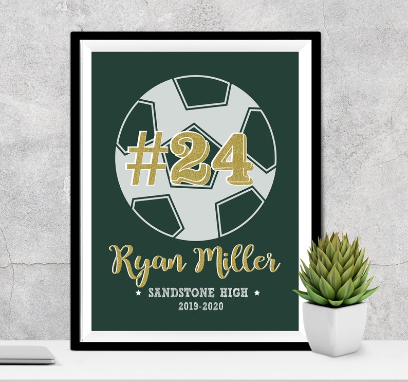 May include: A green and white soccer ball with the number 24 in gold glitter on it. The text "Ryan Miller" is below the ball, followed by "Sandstone High" and "2019-2020".