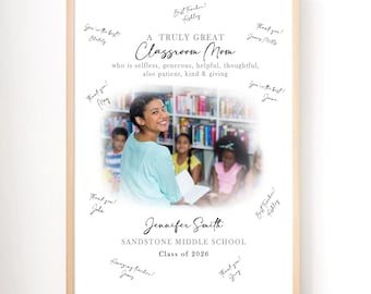 May include: A framed print with a light wood border. The print features a photo of a teacher with students, surrounded by handwritten notes. Text reads "A Truly Great Classroom Mom" and includes the teacher's name, school, and class year.
