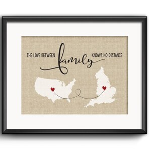 May include: A framed print with a burlap background featuring a map of the United States and the United Kingdom connected by a dotted line. The text "The love between family knows no distance" is written in black cursive script. Red hearts mark the locations of the United States and the United Kingdom.