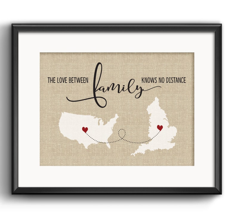 May include: A framed print with a burlap background featuring a map of the United States and the United Kingdom connected by a dotted line. The text "The love between family knows no distance" is written in black cursive script. Red hearts mark the locations of the United States and the United Kingdom.