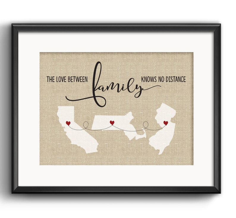 May include: A burlap print with a map of the United States showing three states connected by a dotted line. The states are California, North Carolina, and New Jersey. The text "The love between family knows no distance" is written above the map.