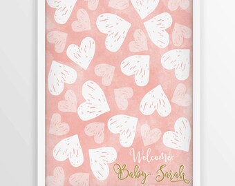 May include: A pink and white baby shower guest book with a heart pattern. The text "Welcome Baby Sarah 09.28.2017" is written in gold glitter.