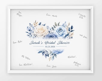 May include: A white framed sign featuring a watercolor floral heart in shades of blue and cream. The text reads Sarah's Bridal Shower and 05.21.2026, surrounded by various handwritten signatures and messages in black ink on a white background.