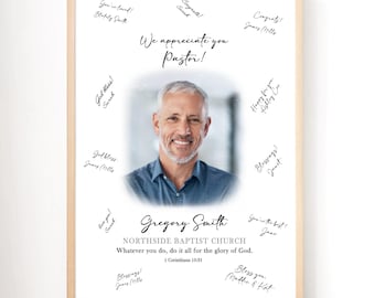 May include: Framed print with a portrait of a smiling man, surrounded by handwritten messages. The text reads "We appreciate you Pastor!" and includes the name "Gregory Smith" and church details. The frame is a light wood color.