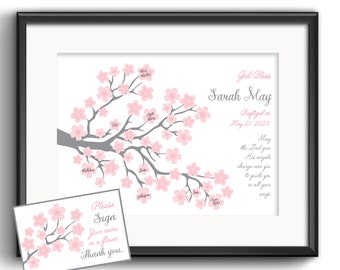 May include: A white framed print with a pink and gray cherry blossom tree. The text "God Bless Sarah May Baptized on May 21, 2023" is printed on the right side of the print. The text "Please Sign Your name on a flower. Thank you." is printed on a separate card.