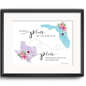 May include: Framed art print featuring watercolor maps of Florida and Texas, connected by dotted lines and hearts. The text includes the words "plans" and a Bible verse. Floral accents adorn the maps, set against a white background.