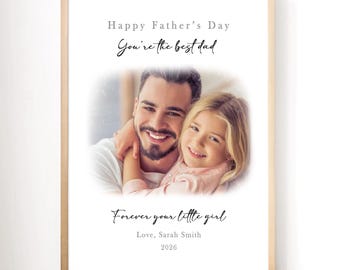 May include: Framed print with a photograph of a father and child, with the text "Happy Father's Day, You're the best dad, Forever your little girl, Love, Sarah Smith, 2026". The frame is a light wood color.