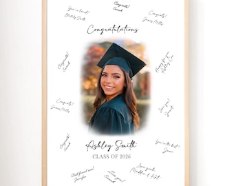 May include: A framed graduation photo featuring a smiling woman in a cap and gown. The photo is surrounded by handwritten congratulatory messages and signatures. The text "Congratulations", "Ashley Smith", and "Class of 2026" are also visible.