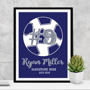 May include: A navy blue printable poster with a white soccer ball and the number 9 in silver glitter. The text "Ryan Miller" is below the ball in silver glitter. The text "Sandstone High 2019-2020" is below the name.