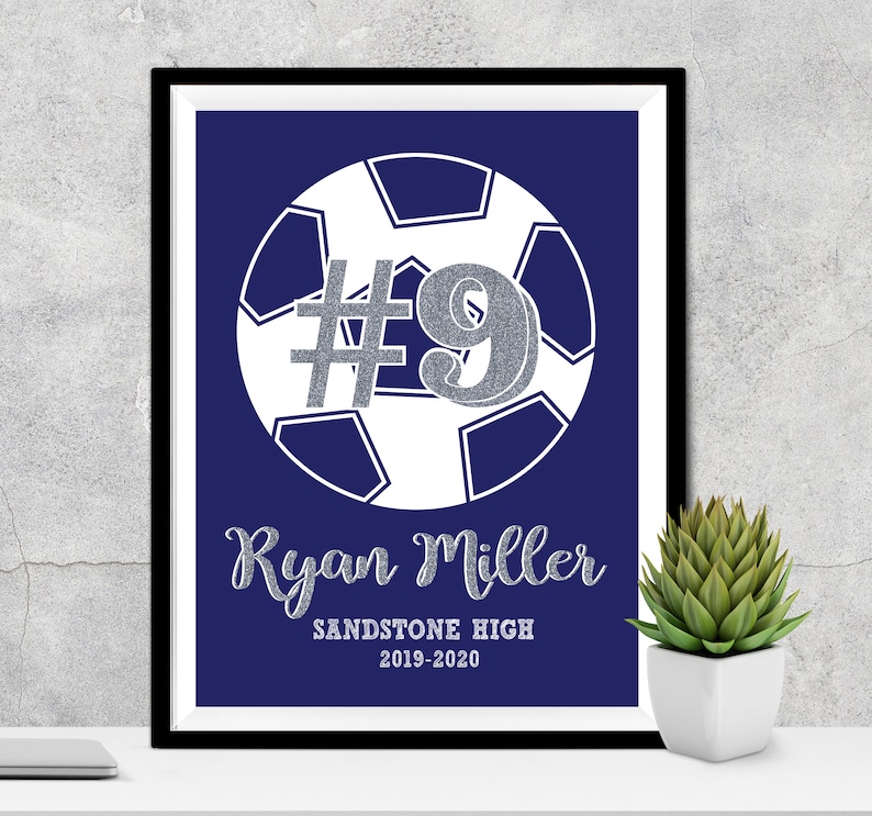 May include: A navy blue printable poster with a white soccer ball and the number 9 in silver glitter. The text "Ryan Miller" is below the ball in silver glitter. The text "Sandstone High 2019-2020" is below the name.