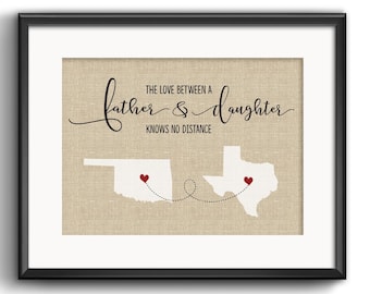 May include: Framed print with the text "THE LOVE BETWEEN A FATHER & DAUGHTER KNOWS NO DISTANCE." The artwork features white outlines of the states of Oklahoma and Texas, connected by a dotted line, each with a red heart.