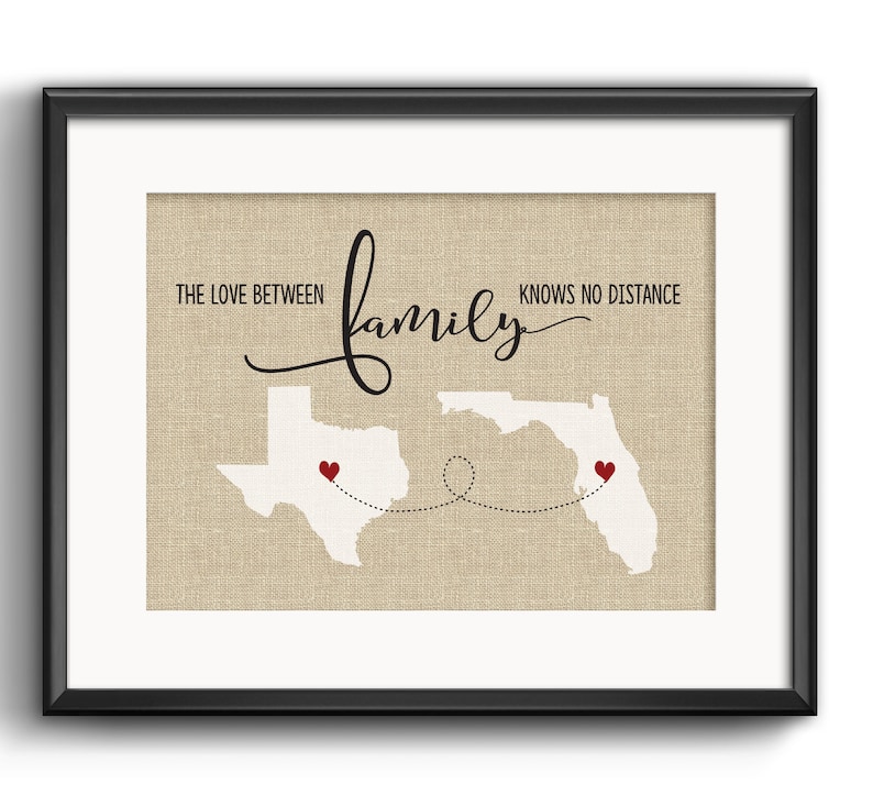May include: A beige canvas print with the text "The love between family knows no distance" and outlines of Texas and Florida with red hearts on each state.