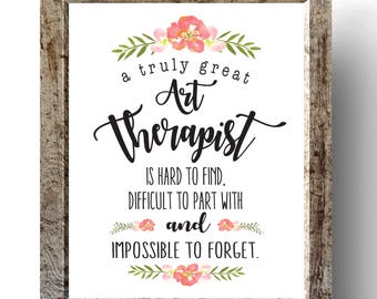 May include: A framed print with a white background and black text that reads "a truly great Art Therapist is hard to find, difficult to part with and impossible to forget." The text is surrounded by pink flowers and green leaves.