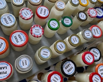 May include: A collection of glass jars filled with white lard, each with a red, white, and blue label that reads "Pure Lard".